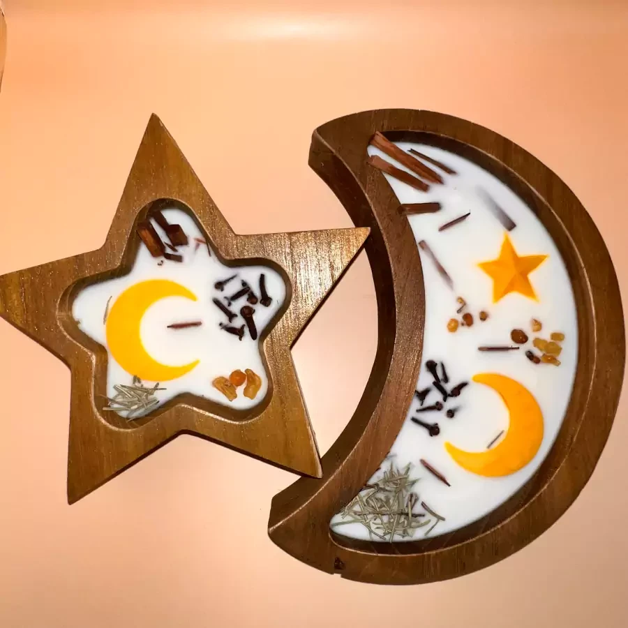 Set of star and moon-shaped candle in wooden plates with scent of incense, sandalwood, cloves and oud