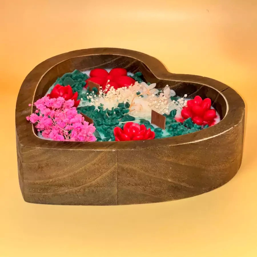 A large rose garden design candle in a wooden heart with the scent of roses