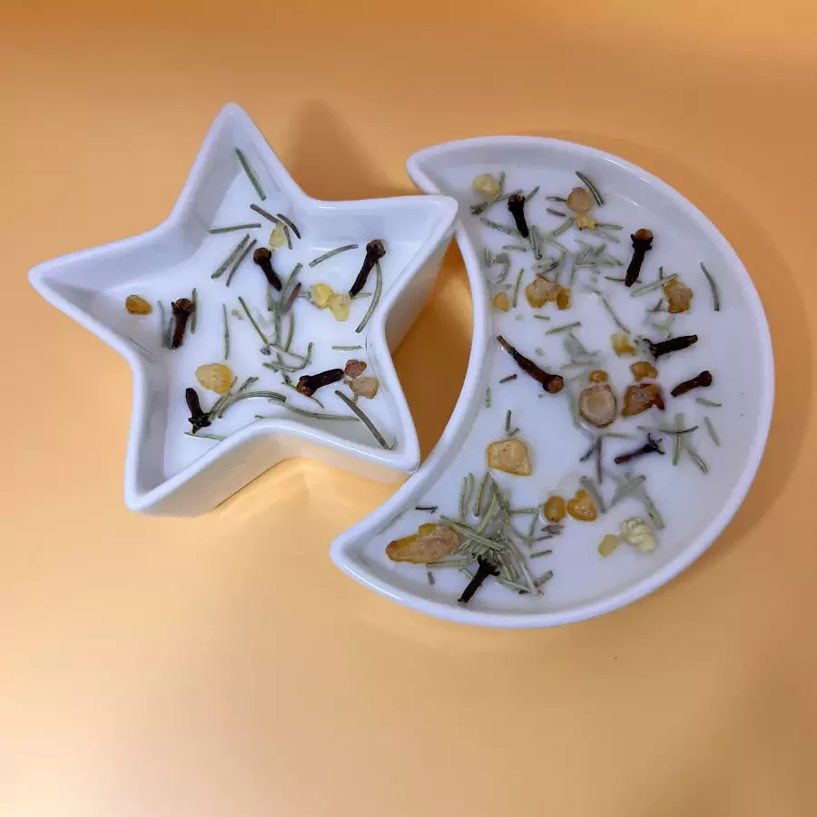 Set of star and moon-shaped candle in glass plates with scent of incense, sandalwood, cloves and oud