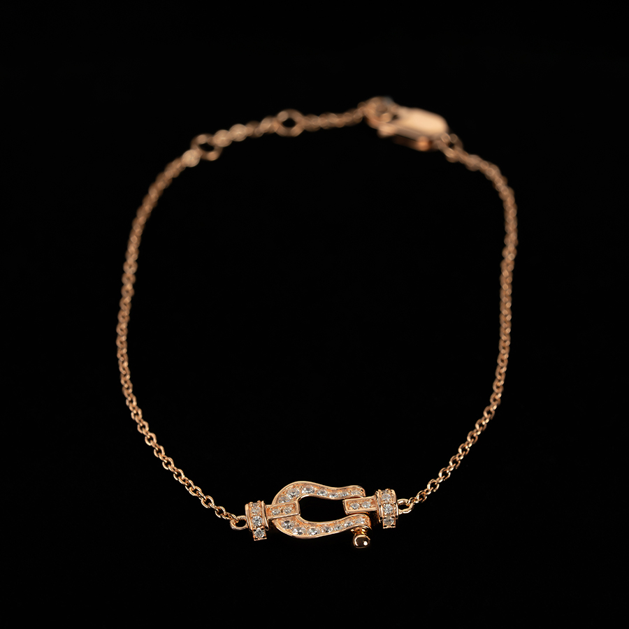 Women's fine bracelet features a delicate horseshoe design, plated in gold