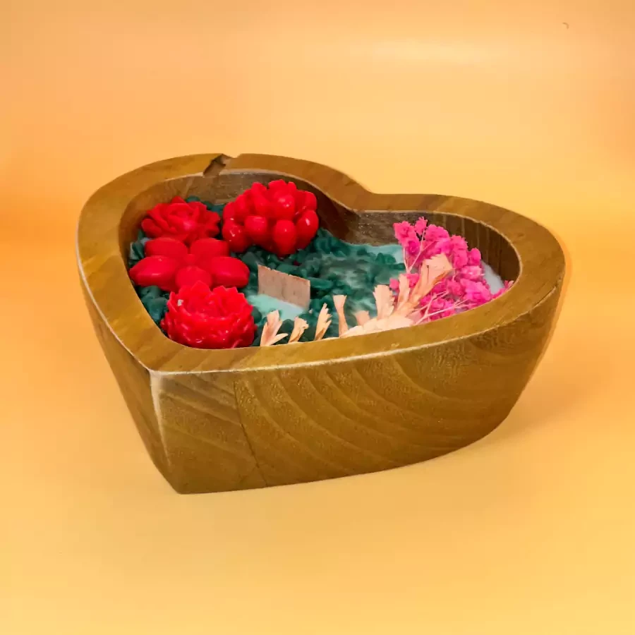 A small rose garden design candle in a wooden heart with the scent of roses